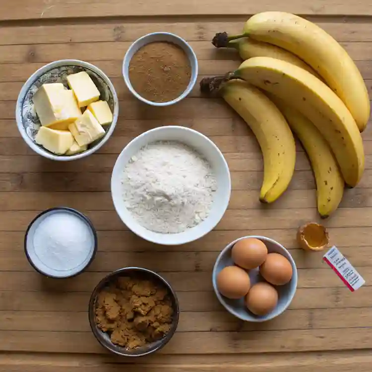 Neatly arranged ingredients for Old Fashioned Banana Bread on a wooden surface