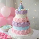 Two-tier pastel princess birthday cake with swirls, sparkles, and princess topper.